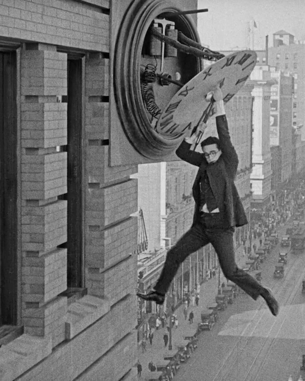 Harold Lloyd hanging from a clock face in Safety Last
